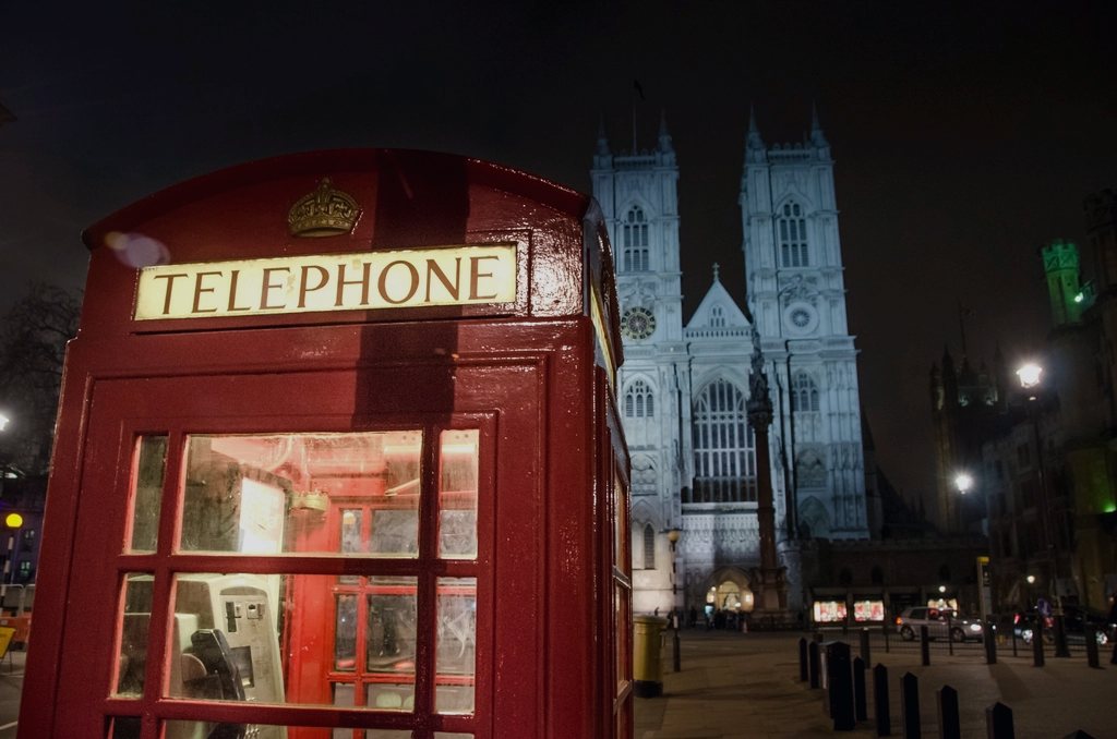 A red telephone box at night